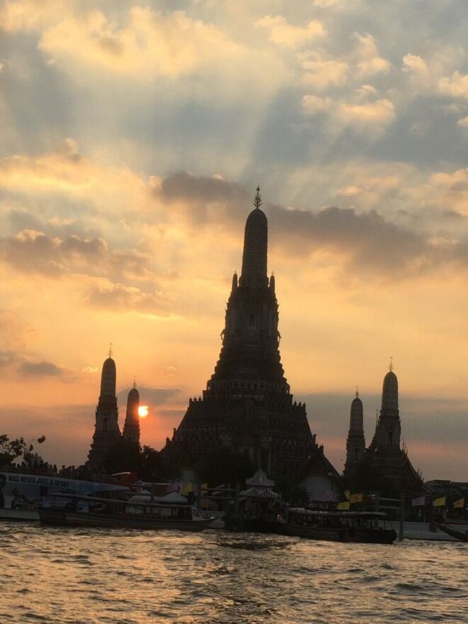 Wat Arun temple on the Chao Phraya River at sunset, Bangkok