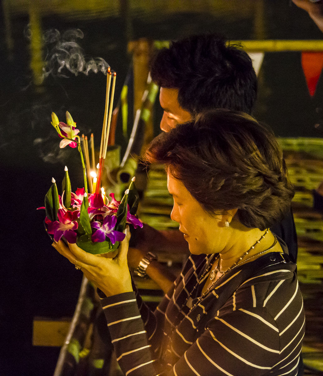 A krathong offering of flowers and candles, held before being floated for Loy Krathong