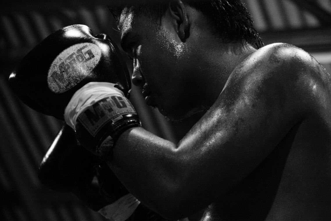 A Muay Thai fighter training, gloves up